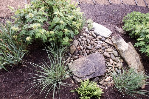 Stone-edged planting beds with gravel and flagstone steps